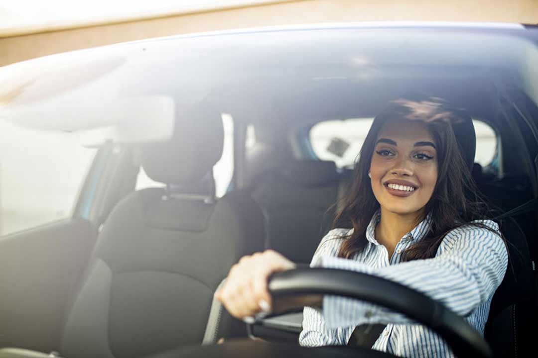 a photo of a woman driving a car
